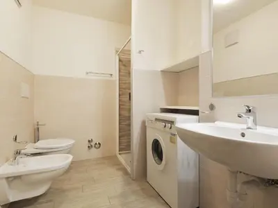 a bathroom with a sink and a washing machine at Apartment Condominio al Parco-5 by Interhome in Canazei