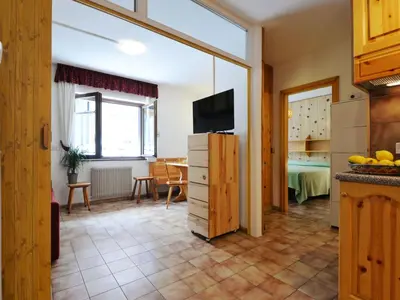 a kitchen with wooden cabinets and a sink at Apartment Cesa Fraines-1 by Interhome in Alba di Canazei