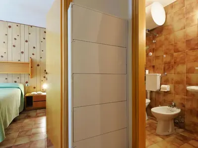 a small bathroom with a toilet and a sink at Apartment Cesa Fraines-1 by Interhome in Alba di Canazei