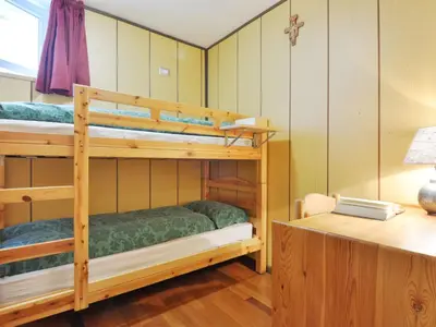 a room with two bunk beds and a desk at Apartment Cesa Fraines-2 by Interhome in Alba di Canazei
