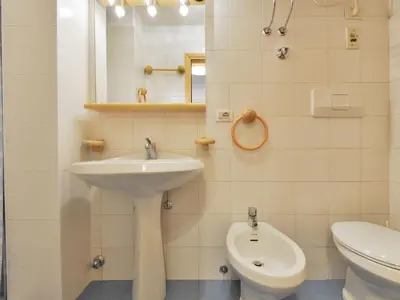 a white bathroom with a sink and a toilet at Apartment Apt 3 by Interhome in Penia
