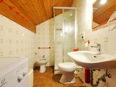 a bathroom with a sink and a toilet and a shower at Apartment Monti Pallidi-3 by Interhome in Canazei