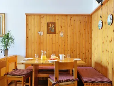 a wooden dining room with a table and chairs at Apartment Condominio al Parco-1 by Interhome in Canazei