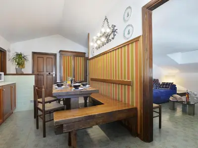 a kitchen with a table and a dining room at Apartment Condominio al Parco-7 by Interhome in Canazei