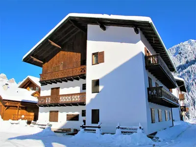 a large building with snow on the ground at Apartment Cesa Fraines-3 by Interhome in Alba di Canazei