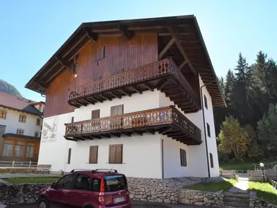 a red car parked in front of a building at Apartment Cesa Fraines-3 by Interhome in Alba di Canazei