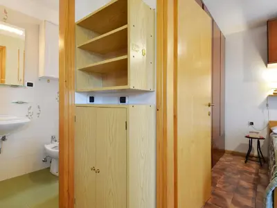 a bathroom with wooden cabinets and a sink at Apartment Cesa Fraines-3 by Interhome in Alba di Canazei