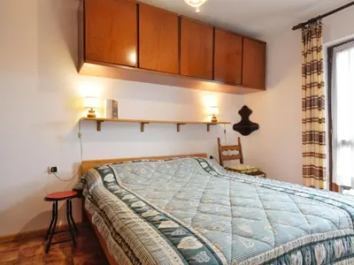 a bedroom with a bed and cabinets and a window at Apartment Cesa Fraines-3 by Interhome in Alba di Canazei