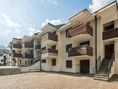 an apartment building with wooden balconies and stairs at Apartment Enrosadira-5 by Interhome in Alba di Canazei