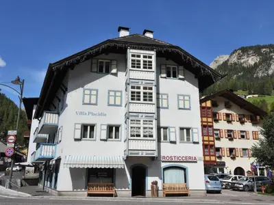 a white building with a black roof at Apartment Villa Placidia Apt 24 by Interhome in Campitello di Fassa