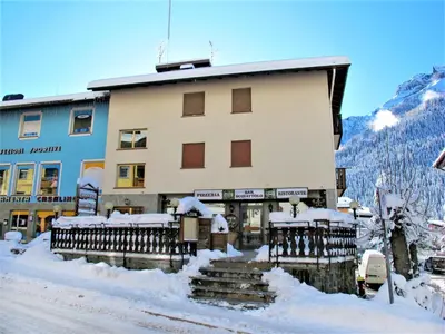 a building in the snow with snow on the steps at Apartment Apt 2 by Interhome in Canazei