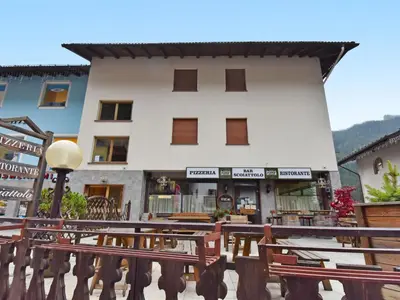 a building with a bunch of benches in front of it at Apartment Apt 2 by Interhome in Canazei