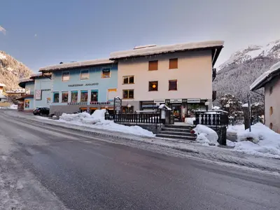 a building on the side of a snow covered street at Apartment Apt 2 by Interhome in Canazei