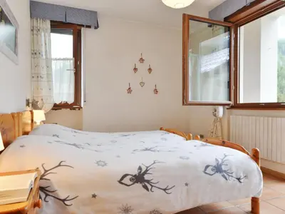 a bedroom with a bed with a bedspread with antlers on it at Apartment Apt 2 by Interhome in Canazei