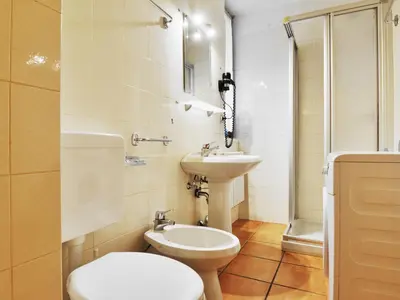 a bathroom with a toilet and a sink at Apartment Apt 2 by Interhome in Canazei
