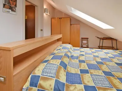 a bedroom with a bed in a attic at Apartment Enrosadira-4 by Interhome in Alba di Canazei