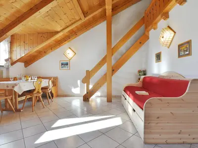 a large white building in front of a mountain at Apartment Villa Placidia Apt 31 by Interhome in Campitello di Fassa