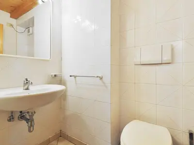 a bathroom with a toilet and a sink in a room at Apartment Villa Placidia Apt 31 by Interhome in Campitello di Fassa