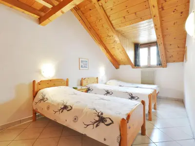 two twin beds in a room with wooden ceilings at Apartment Villa Placidia Apt 31 by Interhome in Campitello di Fassa