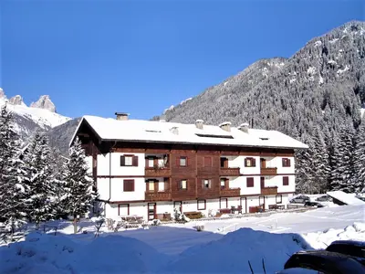 a large building in the snow with a mountain at Apartment Cesa Palua by Interhome in Alba di Canazei