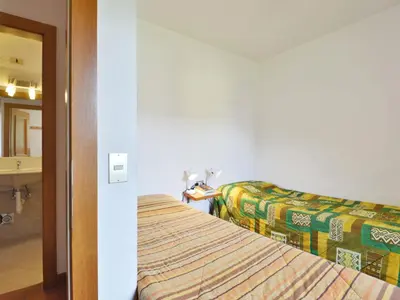 a hotel room with a bed and a mirror at Apartment Cesa Palua by Interhome in Alba di Canazei