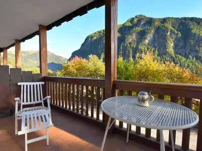 a table and a chair on a balcony with a view at Apartment Villa Bellavista by Interhome in Campitello di Fassa