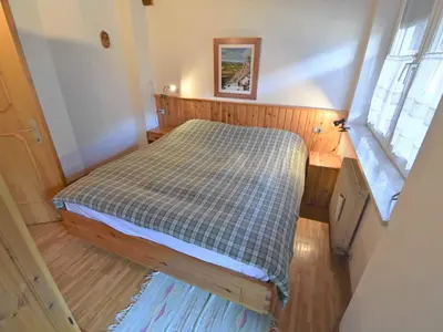 a small bed in a small room with a window at Apartment Villa Bellavista by Interhome in Campitello di Fassa
