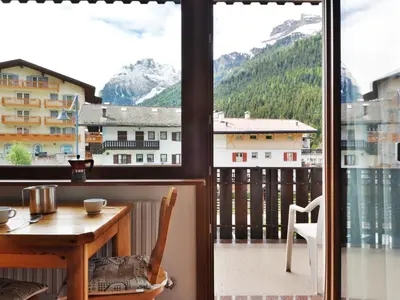 a room with a table and a view of a mountain at Apartment Apt 1 by Interhome in Canazei