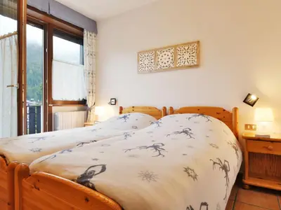 a bedroom with a bed and a window at Apartment Apt 1 by Interhome in Canazei