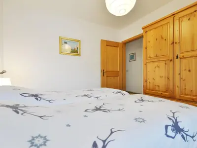a bedroom with a bed with snowflakes on it at Apartment Apt 1 by Interhome in Canazei