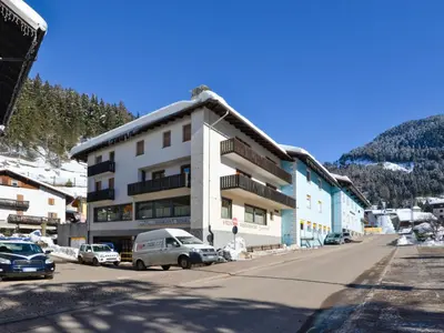 a building on a street with cars parked in front of it at Apartment Apt 3 by Interhome in Canazei