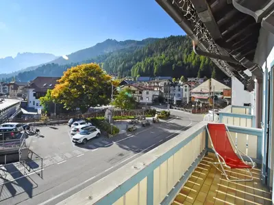 a large white building in front of a mountain at Apartment Villa Placidia Apt 22 by Interhome in Campitello di Fassa