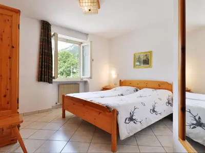 a bedroom with a bed and a window at Apartment Villa Placidia Apt 22 by Interhome in Campitello di Fassa