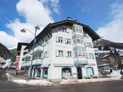a white building with a snow covered roof at Apartment Villa Placidia Apt 33 by Interhome in Campitello di Fassa