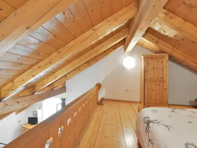 a bed in a room with a wooden ceiling at Apartment Villa Placidia Apt 33 by Interhome in Campitello di Fassa