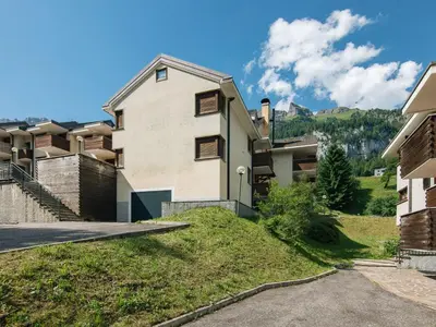 an apartment building with wooden balconies on a street at Apartment Enrosadira-6 by Interhome in Alba di Canazei