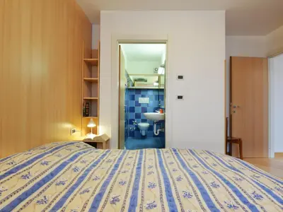 a bedroom with a bed and a window at Apartment Condominio al Parco-3 by Interhome in Canazei