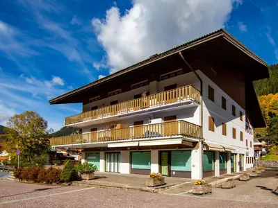 a large building with a mountain in the background at Apartment Condominio al Parco-3 by Interhome in Canazei