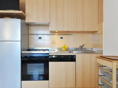 a room with a door and a dining room at Apartment Condominio al Parco-3 by Interhome in Canazei