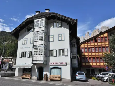 a white building with a black roof at Apartment Villa Placidia Apt 23 by Interhome in Campitello di Fassa