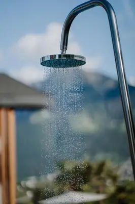 a shower head with water pouring out of it at Das Hallinger am Waidmannhof in Merano