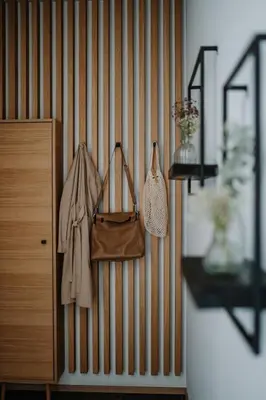 a wooden wall with purses and a purse on it at Das Hallinger am Waidmannhof in Merano