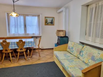 a living room with a couch and a table at NEGRITELLA in Alba di Canazei