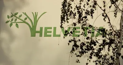 a sign with the word help behind a plant at Appartments Helvetia in Villabassa