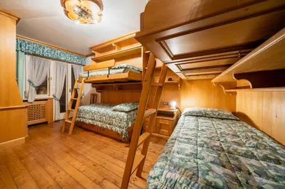 a bedroom with two bunk beds in a room at Villa Radiosa - Stayincortina in Cortina dʼAmpezzo
