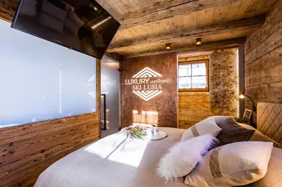 a bedroom with a bed with a large window at Luxury Wellness Lusiaski in Bellamonte