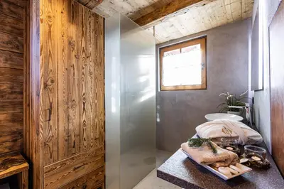 a bathroom with a shower and a table with food at Luxury Wellness Lusiaski in Bellamonte