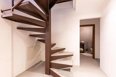 a wooden staircase in a room with white walls at Luxury Wellness Lusiaski in Bellamonte