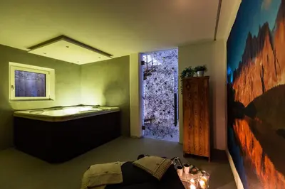 a room with a bathroom with a tub and a window at Luxury Wellness Lusiaski in Bellamonte