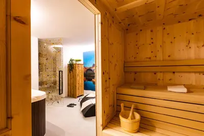 a bathroom with a sauna with wooden walls at Luxury Wellness Lusiaski in Bellamonte
